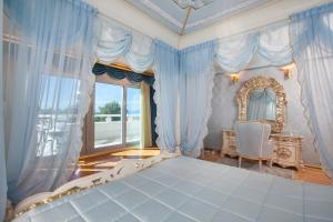 a bedroom with a bed and a chair and a window at Vila Chiara in Makarska +39 photos