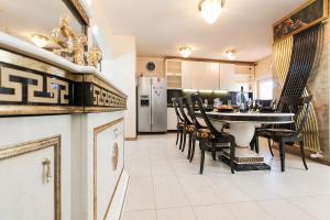 a kitchen and dining room with a table and chairs at Vila Chiara in Makarska