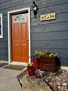 a bike parked in front of a house with flowers at Amazing Views, Northern Lights, Stargazing Entire Guest Suite in Golden, BC Canada in Golden