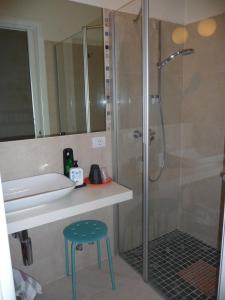 a bathroom with a shower and a stool and a sink at Residence Bed&Bike in Moggio Udinese +47 photos