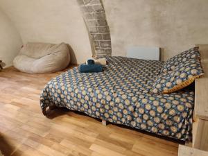 a bedroom with a bed and a bean bag chair at La cave des amoureux in Vogüé