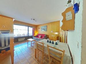 a kitchen and living room with a table and chairs at Studio cosy 4 pers, centre village, parking, ascenseur, balcon - Le Grand-Bornand - FR-1-241-185 in Le Grand-Bornand