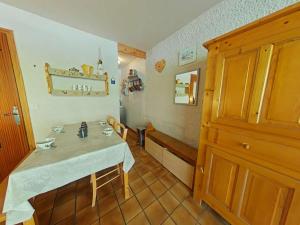 a small room with a table and chairs in it at Studio cosy 4 pers, centre village, parking, ascenseur, balcon - Le Grand-Bornand - FR-1-241-185 in Le Grand-Bornand +8 photos