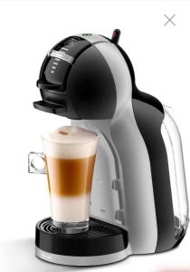 a coffee maker with a cup of coffee at A Ground Floor Maisonette - Mellieha Bay in Is-Sellum