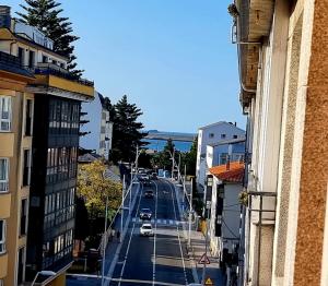 a view of a city street with cars on the road at Alojamiento Misericordia in Viveiro