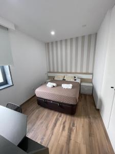 a bedroom with a bed and a wooden floor at The Green Retreat in Torres Vedras
