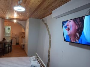 a tv hanging on a wall in a room at Rethymno traditional Studio in Rethymno