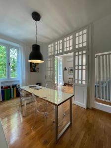 a dining room with a glass table and chairs at Docking House in Lido di Ostia +6 photos