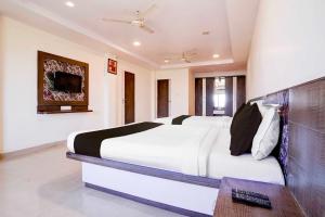 a bedroom with a large bed in a room at Hotel O Mahableshwar Uptown in Mahabaleshwar