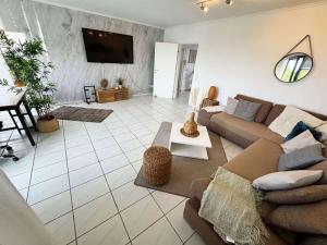 a living room with a couch and a tv at Luxurious Apartment in Leverkusen in Leverkusen