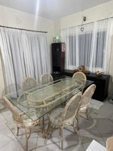 a dining room with a glass table and chairs at A Pérola do Gravatá in Navegantes +43 photos