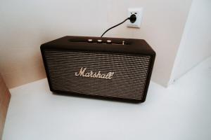 a black radio sitting on a wall next to a outlet at Love & Balneo Week-End in Marseille