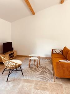 a living room with a couch and a table at Gîte du dousset in Esclottes