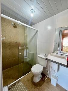 a bathroom with a toilet and a shower and a sink at MeldoMar chalé aconchegante na Pipa in Pipa
