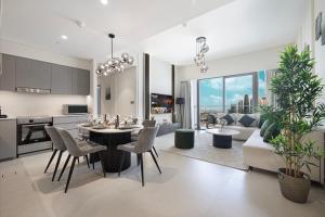 a kitchen and living room with a table and chairs at Sky-High Luxury 2BR Burj View Walk Dubai Mall in Dubai