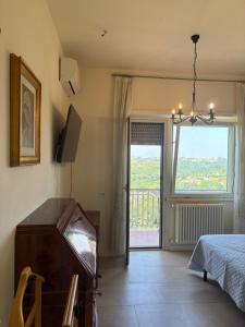 a bedroom with a bed and a dresser and a window at Appartamento Veio in Castelnuovo di Porto