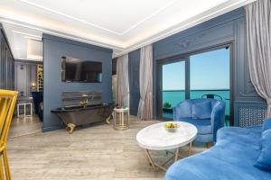 a living room with a blue couch and a tub at MAVİ MARİN BOUTIQUE HOTEL in Ordu