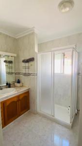 a bathroom with a shower and a sink at Turisblo villa carmen in Benicarló