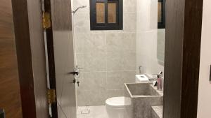 a bathroom with a toilet and a sink at Alzahraa Studio in Jeddah