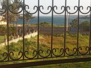 a view of the ocean from a fence at Oysterbay Palm Terrace serviced apt-nyali in Mombasa +2 photos