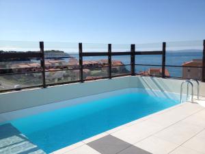 a swimming pool with a view of the ocean at Ibis Styles Collioure Port Vendres in Port-Vendres