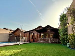 a house with a green lawn in front of it at شاليهات ديلان in Riyadh