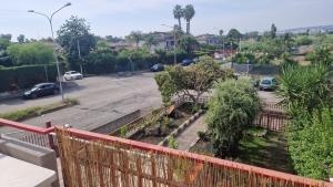 a view of a parking lot from a balcony at Stone beach holiday home in Mascali