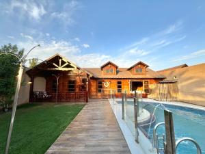a home with a swimming pool and a house at شاليهات ديلان in Riyadh
