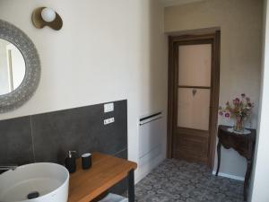 a bathroom with a tub and a sink and a mirror at Cascina della Contessa Suite in Roccaforte Mondovì +10 photos