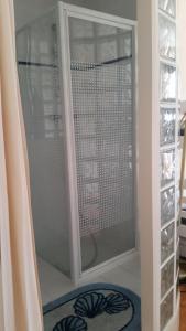 a glass door to a shower in a room at Ker Stella in Plérin