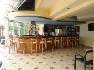 a bar with a bunch of stools in a room at La Luna Apartments in Stalida