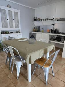 a kitchen with a table and chairs in a kitchen at Lazy Tilapia in Baie du Tombeau