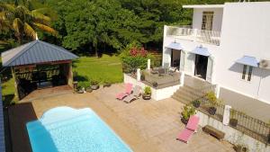 an aerial view of a house with a swimming pool at Lazy Tilapia in Baie du Tombeau