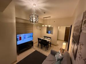 a living room with a table and a dining room at HAVEN on the 28th in Manila
