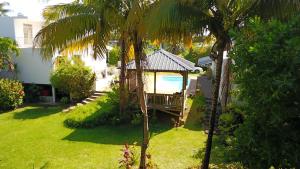 a backyard with a gazebo and a swimming pool at Lazy Tilapia in Baie du Tombeau