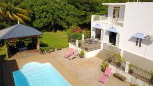 an aerial view of a house with a swimming pool at Lazy Tilapia in Baie du Tombeau