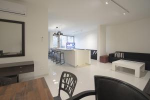 a living room with a table and chairs at Tabarja Heights in ‘Ayn aş Şughayrah