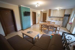 a living room and kitchen with a couch and a table at Agroturystyka Pod Strażnicą in Lutowiec