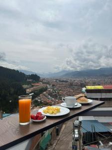 a breakfast of eggs and toast and a glass of orange juice at Departamentos Santa Ana Barrio Tradicional in Cusco