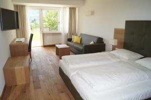 Postel nebo postele na pokoji v ubytování Hotel Greifenstein