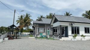 a small house with a playground in front of it at D'Lamp Studio in Kampung Kuala Besut