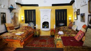 a large room with two beds and a fireplace at Dancing Cloud Art House in Uçhisar