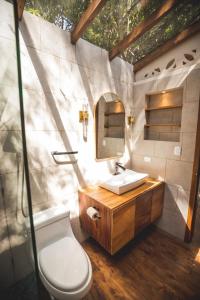 a bathroom with a toilet and a sink at Luxury Lakefront Retreat at Casa Floresta in San Marcos La Laguna +119 photos