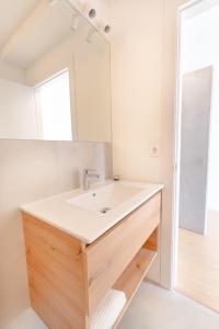 a bathroom with a sink and a mirror at U M I surf yoga suite Doniños beach in Ferrol