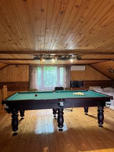 a pool table in a room with a ceiling at Карпатська Модрина in Kosiv +169 photos