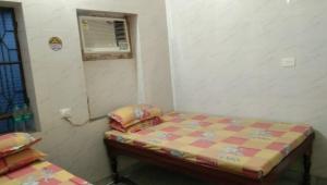 a small room with a bed and a window at Milan, Khatushyamji in Khātu +4 photos