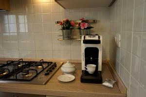 a coffee maker on a counter next to a stove at Manoppello Scalo Two-room apartment & parking in Brecciarola