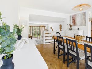 a kitchen and dining room with a table and chairs at Luxury Beach Stay with Hot Tub in Burry Port