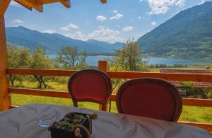 a table with two chairs and a bowl of food on it at Panorama Plavsko Jezero in Plav