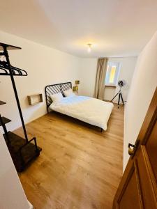 a bedroom with a bed and a wooden floor at Casa Papavero in Gambarogno